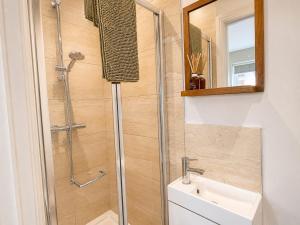 a bathroom with a shower and a sink at Appletree Cottage in Wells