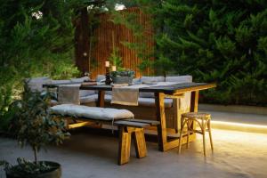 a wooden table with chairs and a table and a table and chairs at Villa Steana in Makri