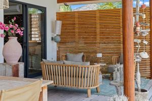 a patio with a bench and a wooden wall at El Patrón, the villa in Jan Thiel +50 photos
