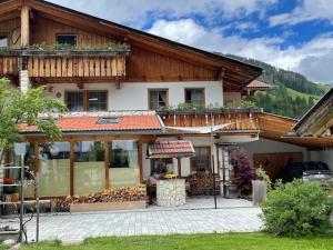 a large wooden house with a balcony on top at Haus Priller in Sillian