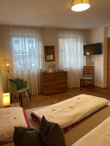 a bedroom with a large bed and a dresser at Haus Priller in Sillian