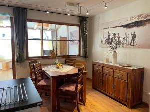 a dining room with a table and a table and chairs at Haus Priller in Sillian