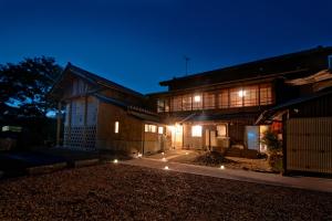 a building with lights in front of it at night at ISEZI Historic Machiya in Shibata