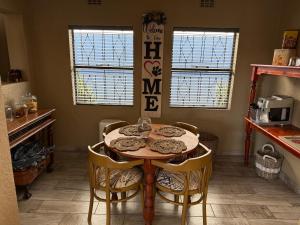 a kitchen with a table and chairs in a room at Sweet Willa Bed and Breakfast in Roodepoort