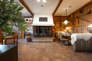 a large room with a fireplace and a table and chairs at Hotel Pelikan in Papenburg