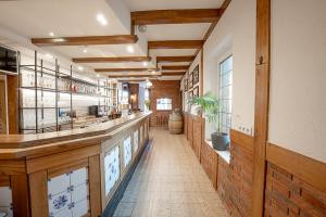 a long hallway with a bar in a restaurant at Hotel Pelikan in Papenburg +25 photos