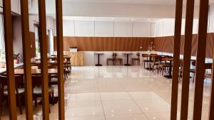 a dining room with wooden tables and chairs at mh town in Ulaanbaatar