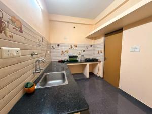 a kitchen with a sink and a counter top at De Quite Villa in Pondicherry