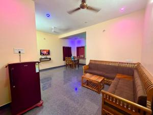 a living room with a couch and a table at De Quite Villa in Pondicherry