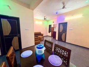 a dining room with a table with plates on it at De Quite Villa in Pondicherry +16 photos