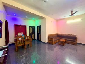 a living room with a couch and a table at De Quite Villa in Pondicherry