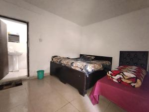 a room with a bed and a table and a window at My Chopta Resort in Sari