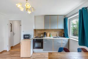 a kitchen with a sink and a stove at Yellow in Miltenberg