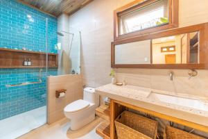 a bathroom with a toilet and a sink at Camanolo Residence in General Luna +25 photos