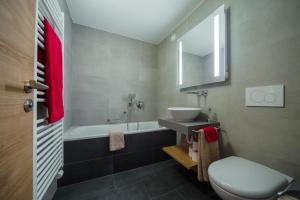 采尔马特Apartment Riffelberg的带水槽、马桶和浴缸的浴室