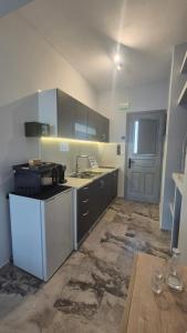a kitchen with a sink and a stove in it at Wide shore Apt in Kamári +8 photos
