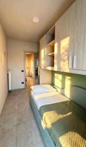 a bedroom with a large bed in a room at Casa Nanà - Sottomarina in Chioggia