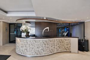 a hotel lobby with a reception counter with luggage at Modern Ocean View Apartment in Cape Town