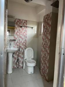 a bathroom with a toilet and a sink at Lakecity Apartment in Pokhara +4 photos