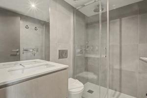 a bathroom with a shower and a toilet and a sink at Apartamento do Laço in Aveiro +17 photos