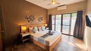 a bedroom with a bed and a large window at Blue Planet Panglao in Panglao Island