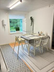 a kitchen with a table and chairs and a refrigerator at Gränna View in Gränna