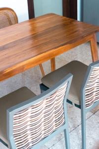 a wooden table with two chairs and a wooden table at Alami Apartment Seminyak in Seminyak +37 photos