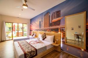 a bedroom with a large bed with a large window at Blue Planet Panglao in Panglao Island