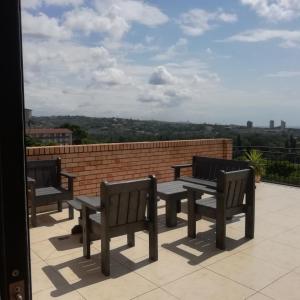 a group of benches sitting on top of a roof at Royal Ushaka Hotel Morningside in Durban