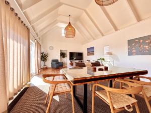 a living room with a dining room table and chairs at Brückendorf 11 Self-catering townhouse in Swakopmund