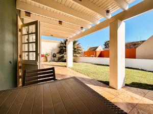 a patio with a bench and a door to a yard at Brückendorf 11 Self-catering townhouse in Swakopmund