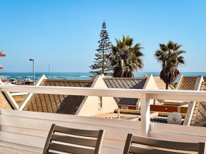a view of the beach from a balcony with two chairs at Brückendorf 11 Self-catering townhouse in Swakopmund