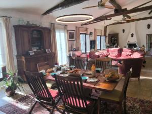 a dining room and living room with a table and chairs at Le bateau sur les toits in Cotignac