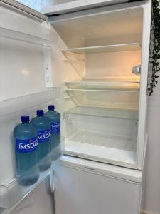 two bottles of water are sitting in an open refrigerator at Gränna View in Gränna