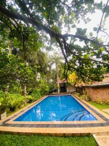 a swimming pool in the yard of a house at Pavana Hotel Negombo in Negombo