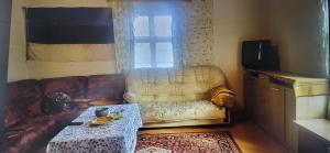 a living room with a couch and a table at Reedi talu in Rädi