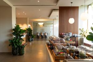 a store with potted plants and motorcycles in a room at Hotel Daniel Graz - Smart Lifestyle Near City Centre in Graz