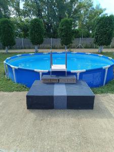 a chair sitting in front of a swimming pool at Apartmani Morava 54 in Kočino Selo