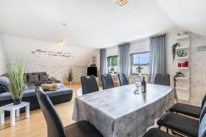 a living room with a large table and chairs at Fewowe Ferienwohnung Wenden in Wenden