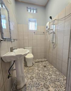 a bathroom with a sink and a toilet at Akagera Sunset House in Kabarondo +17 photos