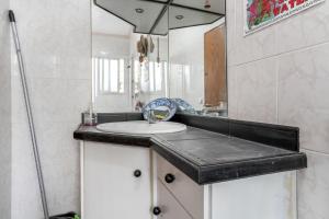 a bathroom with a sink and a mirror at Casa Pantha in Vélez-Málaga