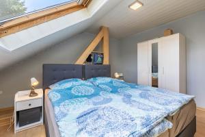 a bedroom with a large bed in a attic at Fewowe Ferienwohnung Wenden in Wenden