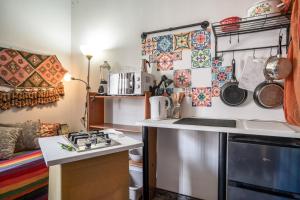 a small kitchen with a stove and a counter top at Casa Pantha in Vélez-Málaga +18 photos