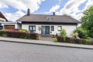 a white house on the side of a street at Fewowe Ferienwohnung Wenden in Wenden