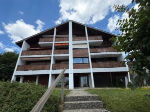 a tall building with stairs in front of it at Appartement de charme rénové in Charmey