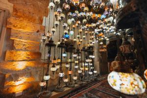 a room with a bunch of lights hanging from a wall at Velum Cappadocia in Göreme