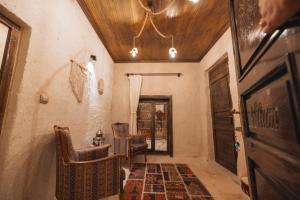 a hallway with a room with a door and chairs at Velum Cappadocia in Göreme