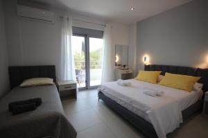 a bedroom with a large bed and a window at Avli Rooms in Himare