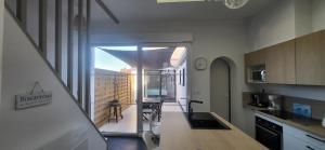 a kitchen with a view of a balcony at Le Cocon des Sables in Sangatte