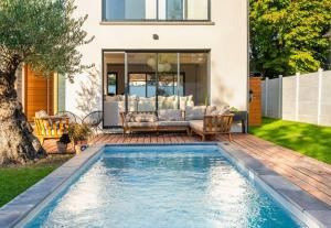 a swimming pool in the backyard of a house at House Moringa Rituals Pool in Le Plessis-Trévise